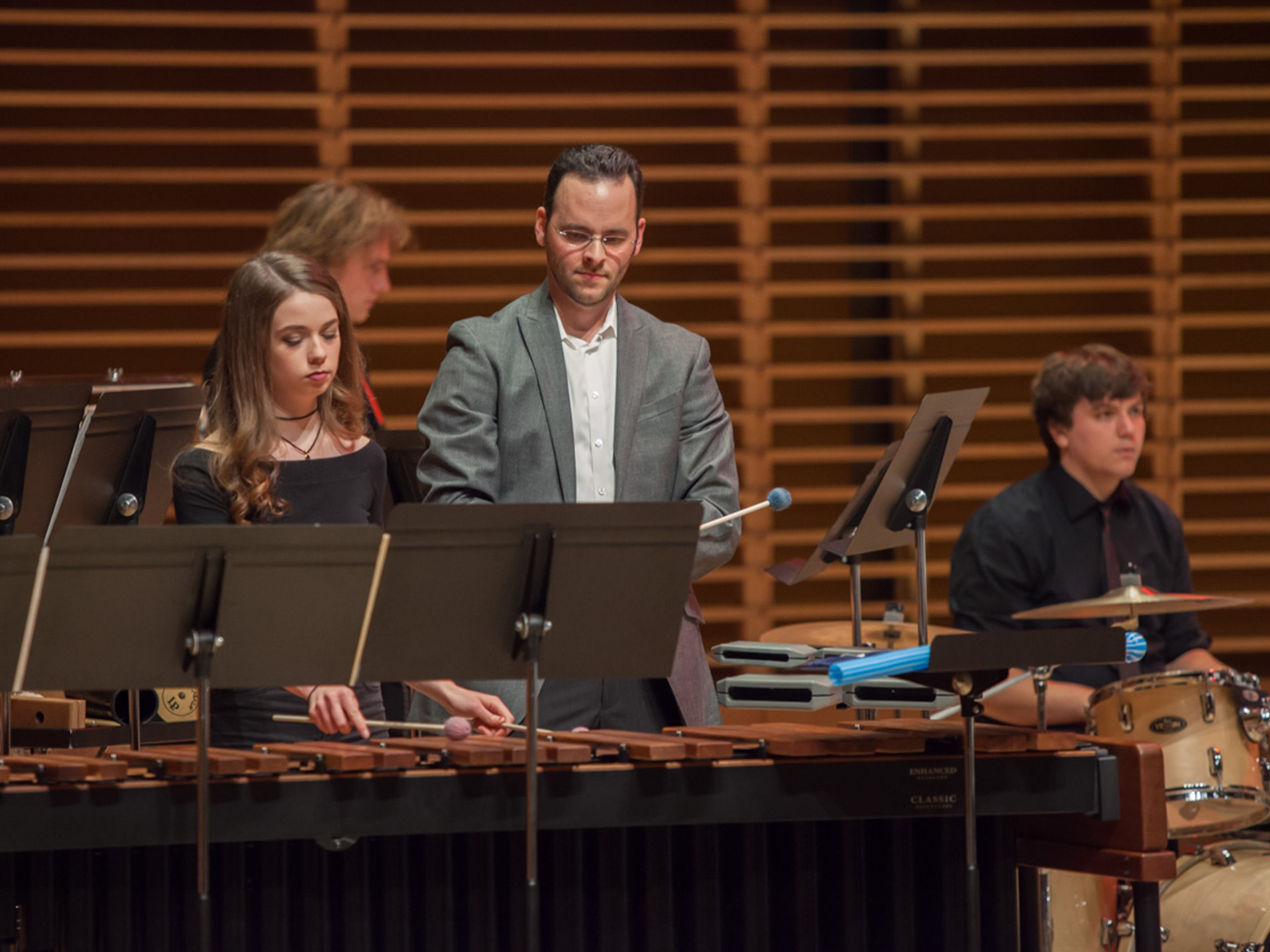 Jeff Calissi performing on stage with students