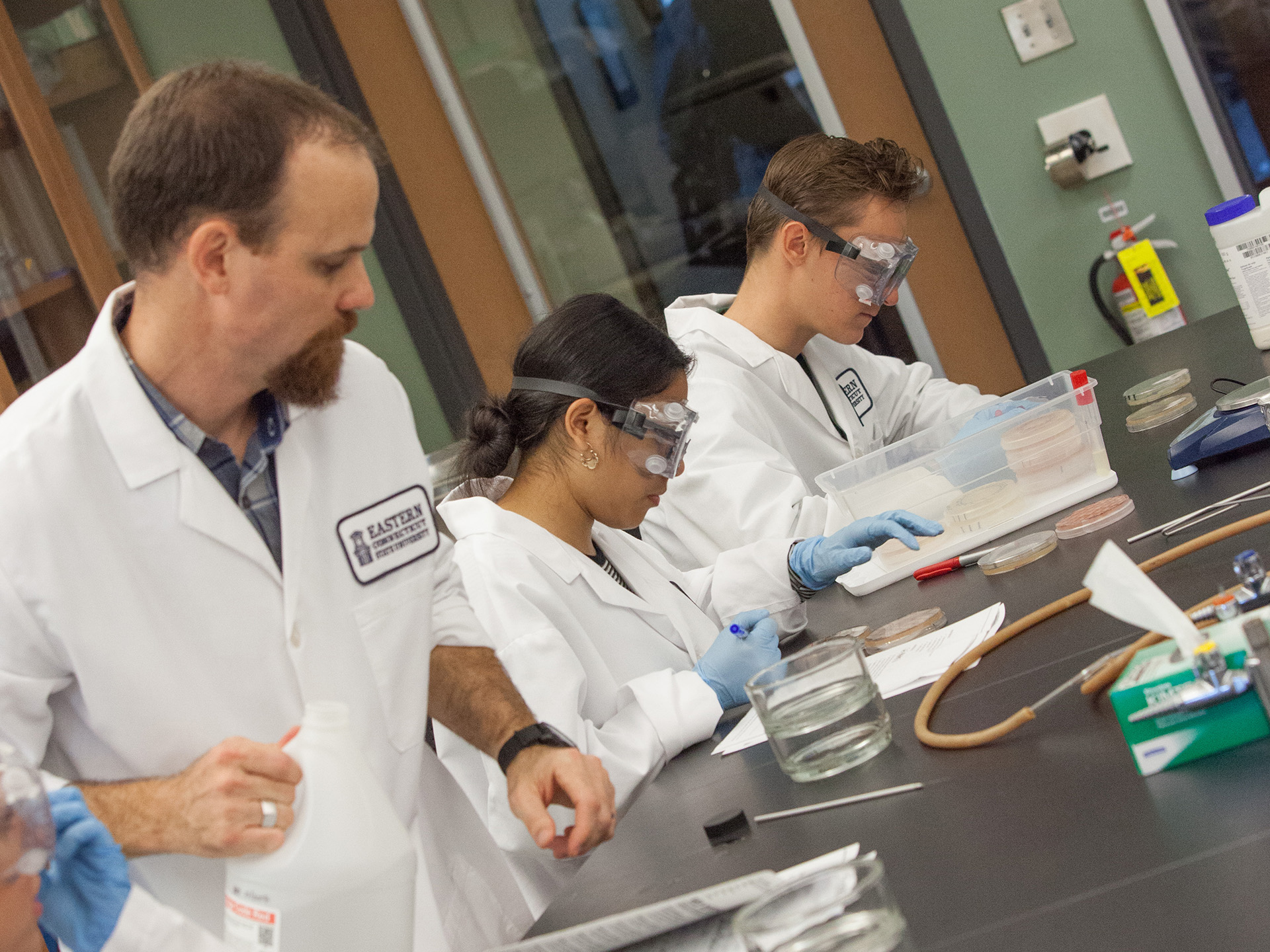 Jonathan Hulvey doing lab work with students