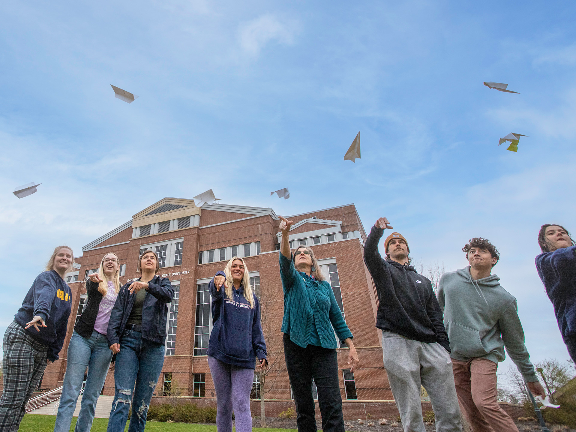 Laura Rodriguez and students tossing paper planes