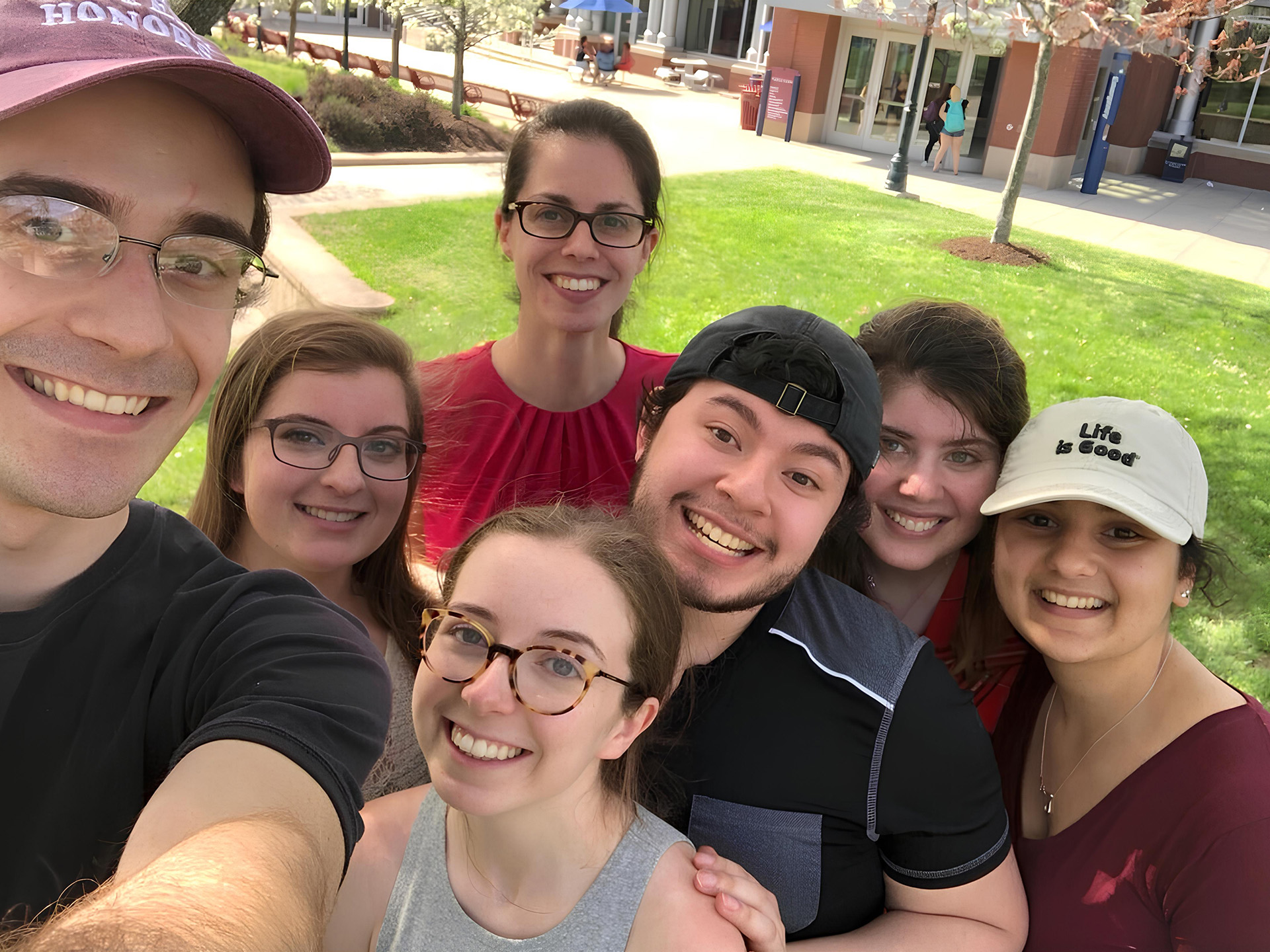 Jenna Scisco posing for photo with students