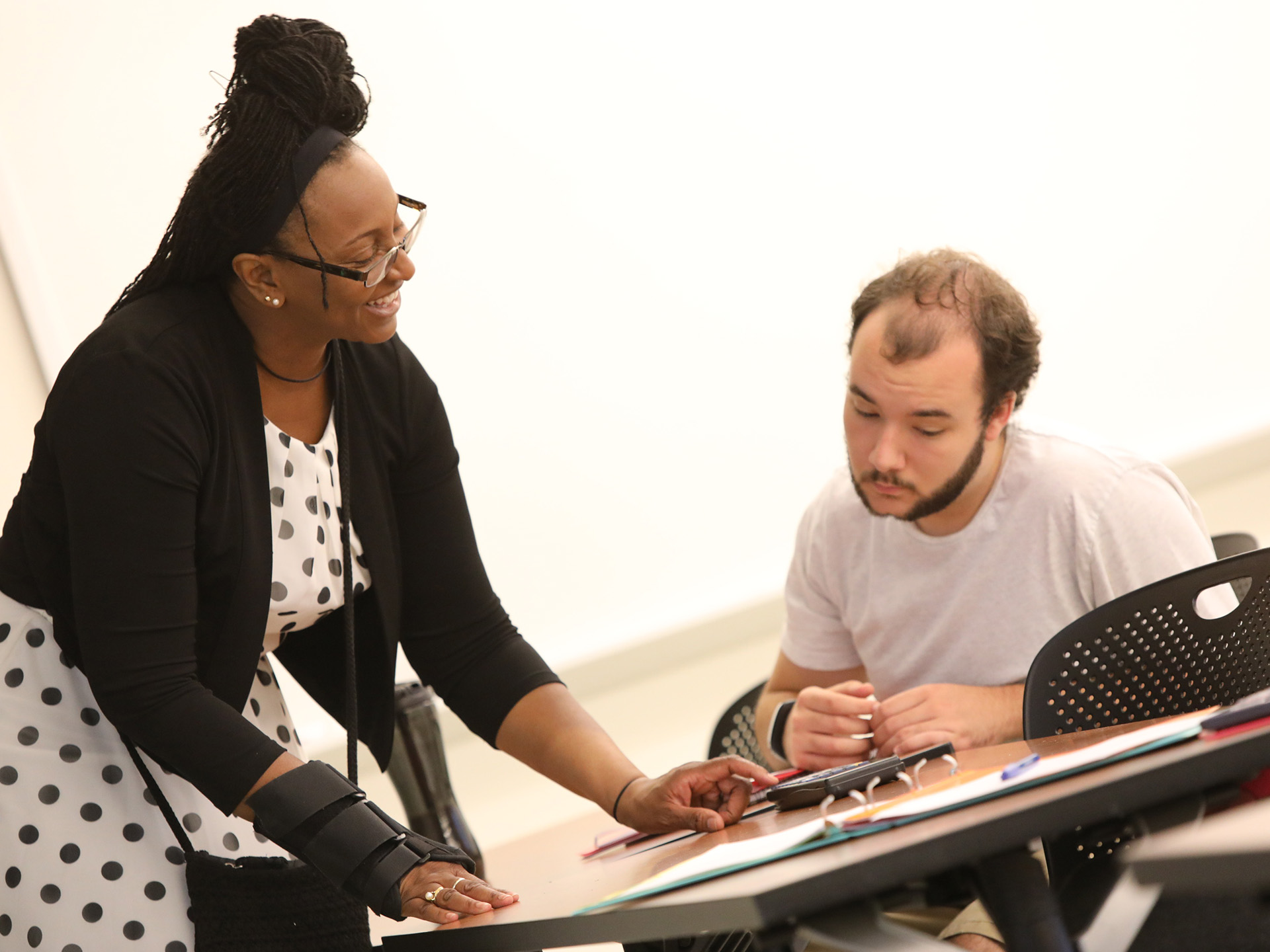 Kim Ward helping a student in class