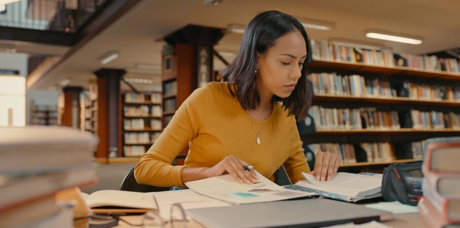 Young, female professional analyzing data in a library.