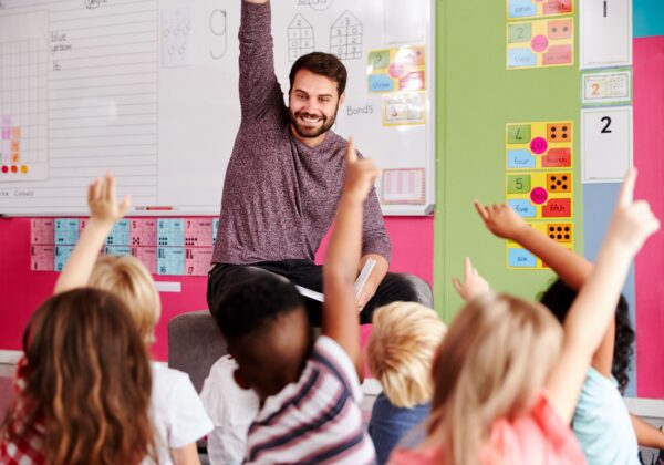 Teacher reading to students in classroom.