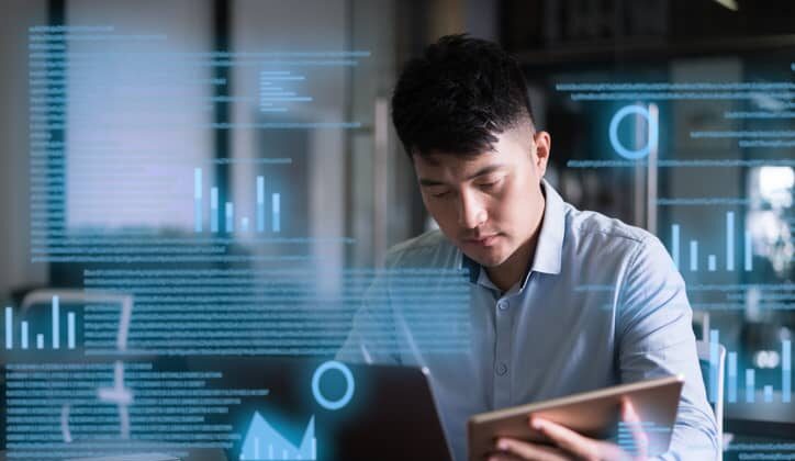 Male accountant uses a laptop on a virtual screen.