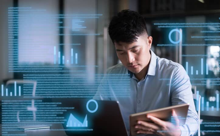 Male accountant uses a laptop on a virtual screen.