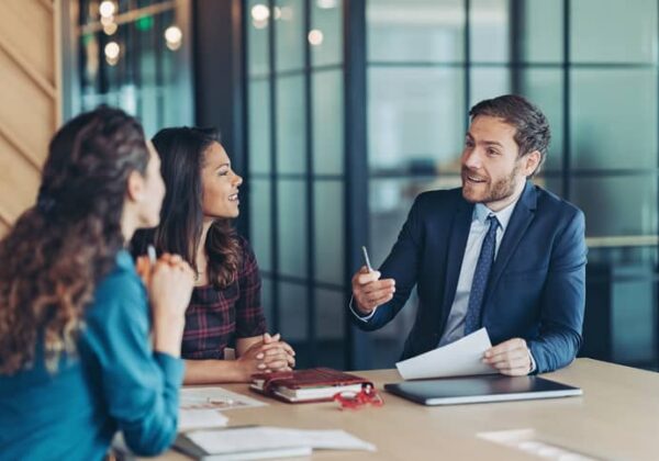 Male accountant shares his expertise and ideas in a meeting with two women.