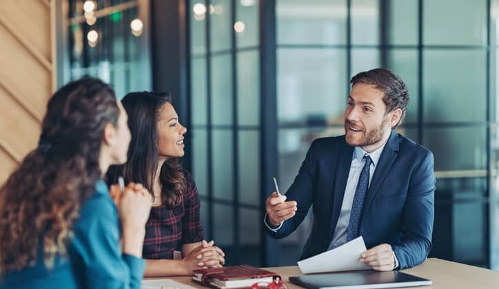 Male accountant shares his expertise and ideas in a meeting with two women.