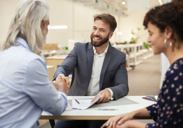 A CPA shakes hands with happy clients