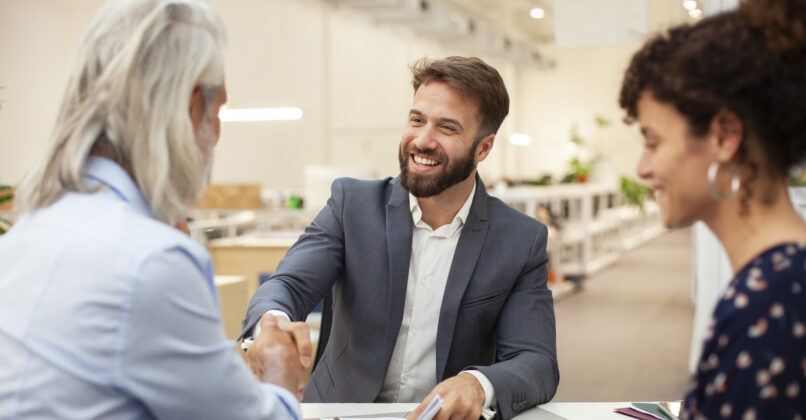 A CPA shakes hands with happy clients