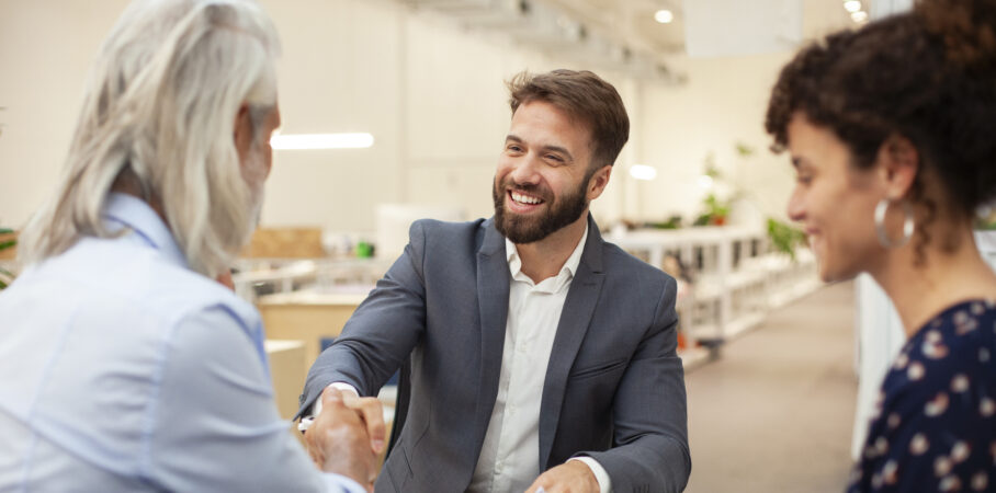 A CPA shakes hands with happy clients