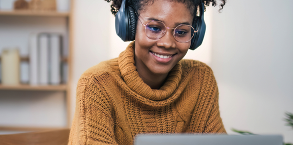 Student smiling while working on coursework