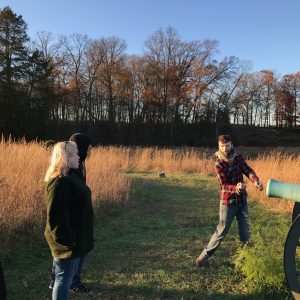 At the Wheatfield, student Gerri Denardi explains how to load a Civil War era cannon to students Margaret Conroy and Zack Dubois.