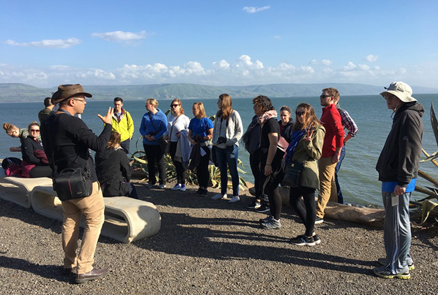 Students and professor abroad at the Sea of Galilee
