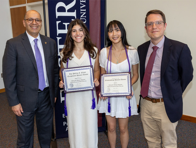 Eastern's President Karim Ismaili and Professor Timothy Cochran with recipients of an award for exceptional honors thesis, Hailey Cocca and Anne Le