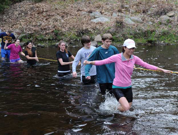 students crossing deep water