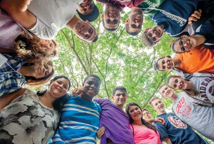 students hunched over in a circle