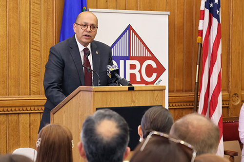 President Karim Ismaili speaking at a podium
