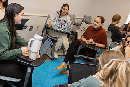 professor talking with students during class