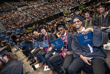 students in cap and gown posing for a photo during graduation