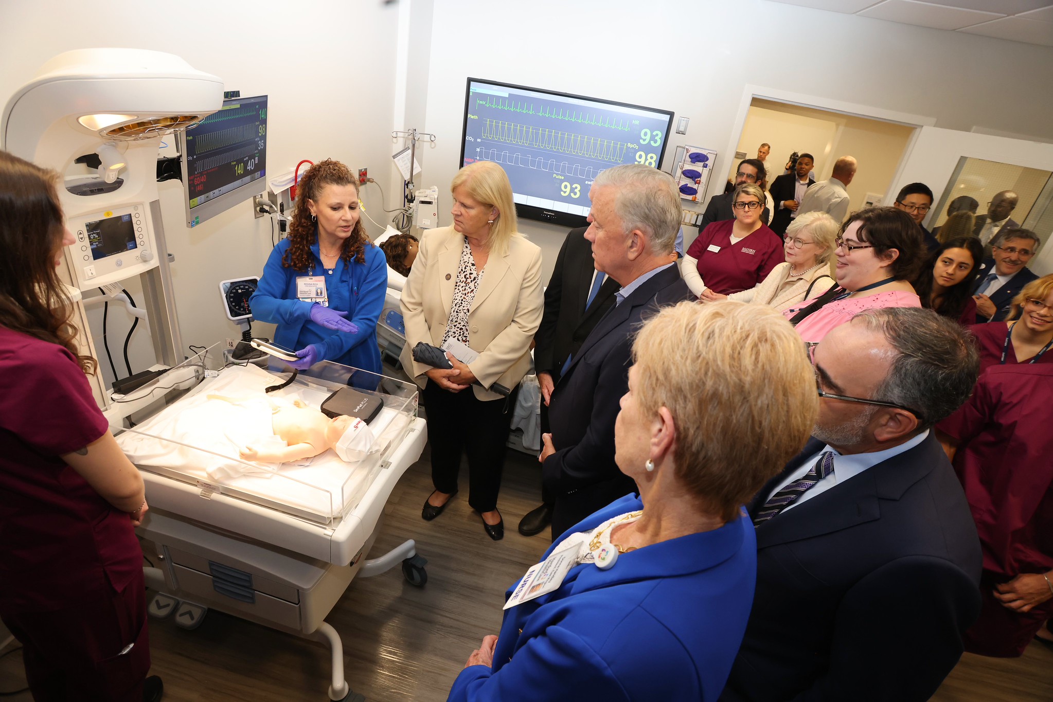 Visitors touring a nursing simulation lab with patient monitors
