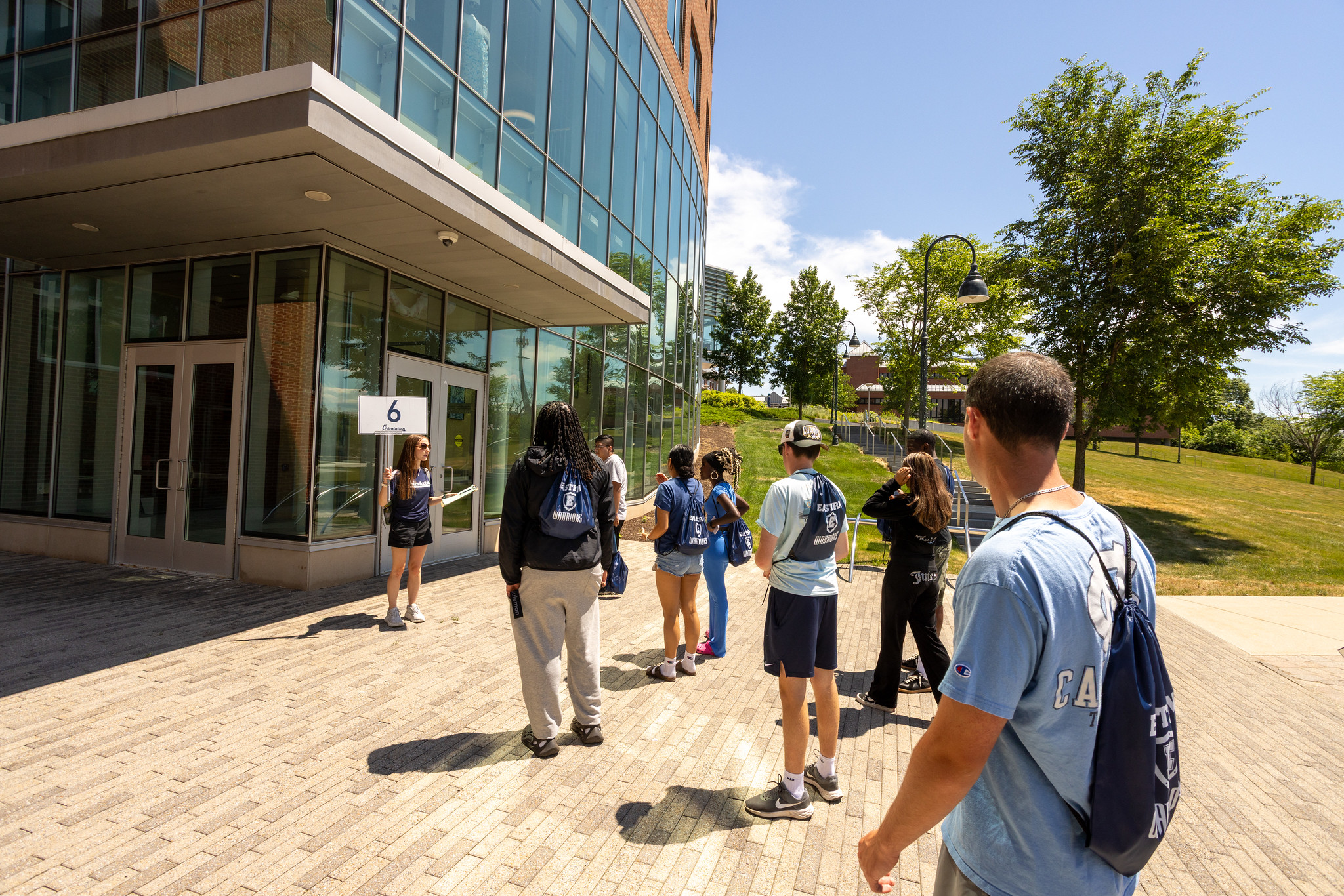 New students with Eastern Warriors bags on an orientation campus tour