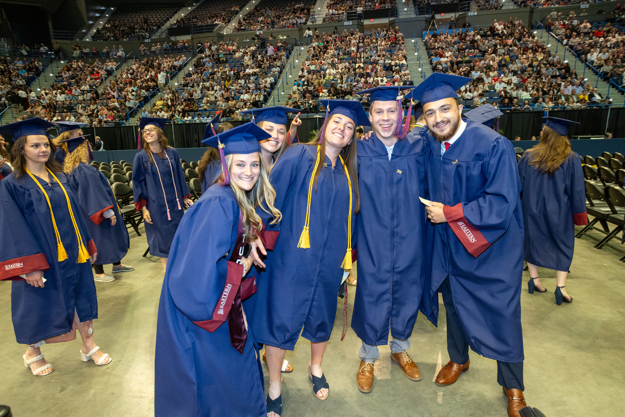 Graduates in caps and gowns celebrating at commencement
