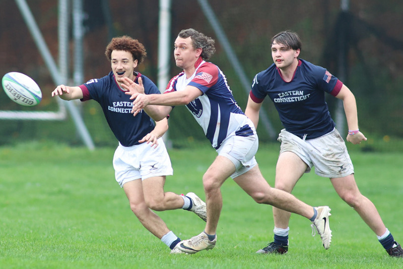 Anthony Amato and two members of the Eastern rugby team playing in the spring 2025 rugby alumni match