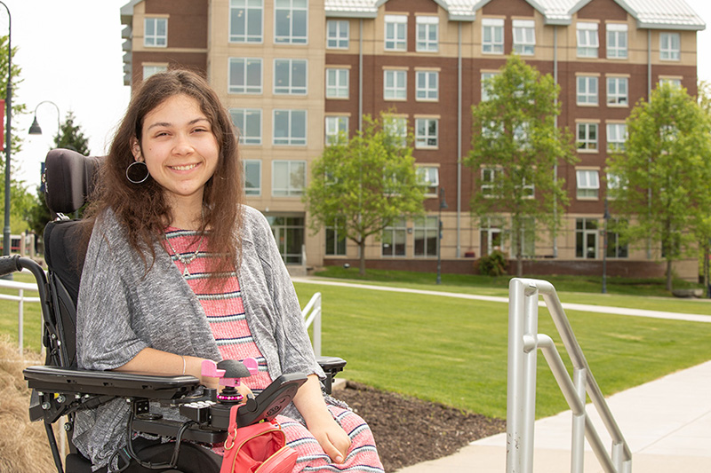 Abigail Dreyer in her wheelchair in front of Eastern's quad