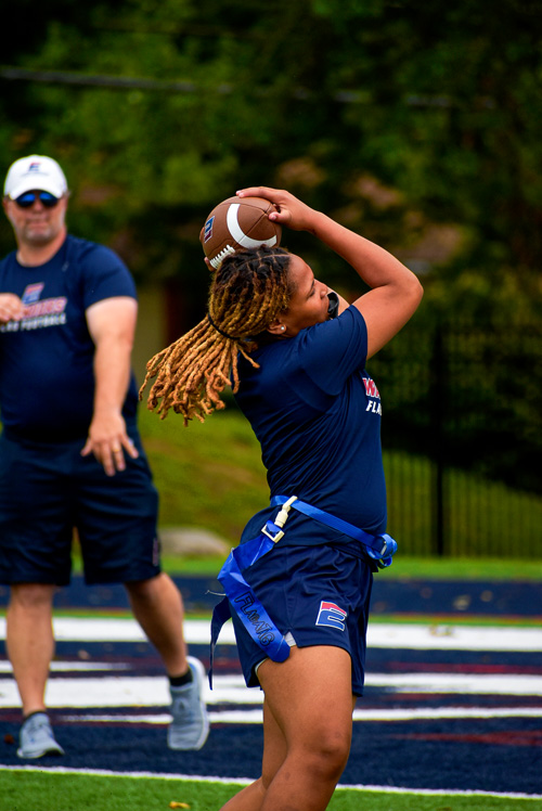  A team member catches a football during practice.