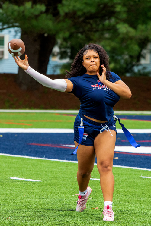 A team member throws a football during practice.