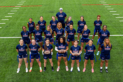 Eastern's inaugural women's flag football team poses for a team photo on their recently finished turf field.