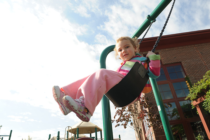child swinging on a swingset