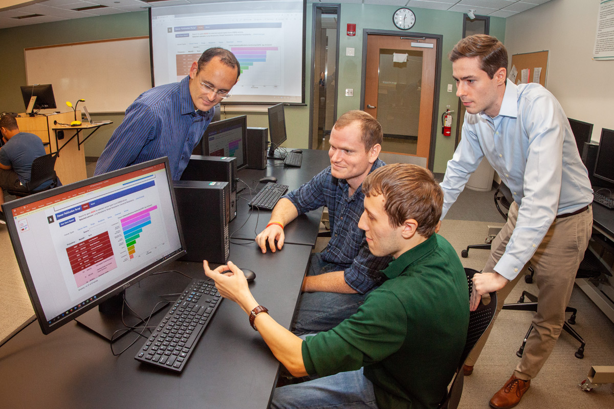 Professor and student working at a computer