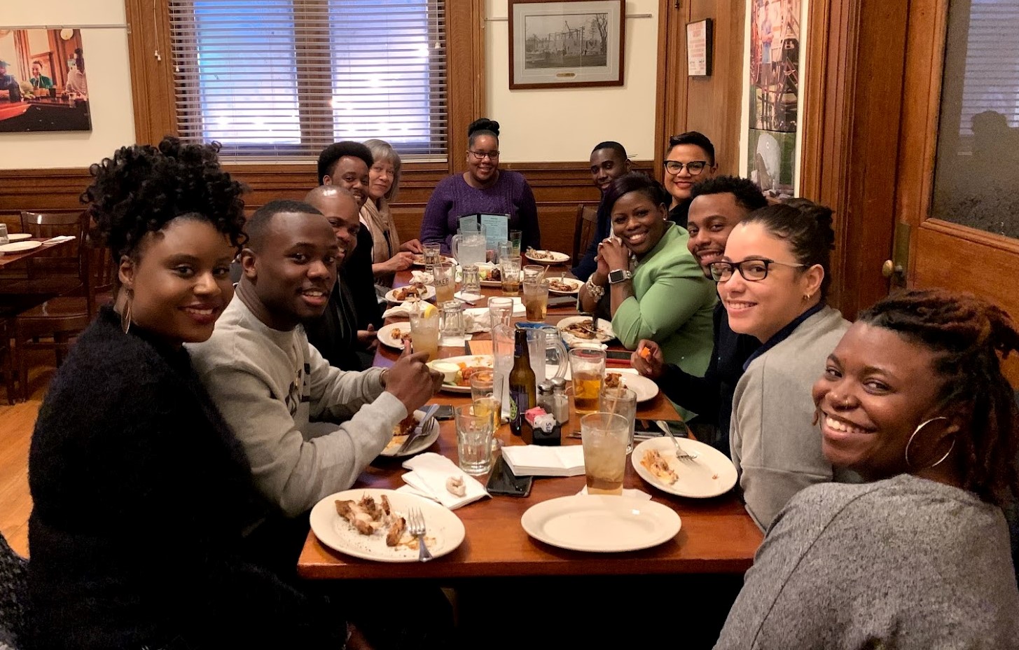 a group of students sitting around a table eating