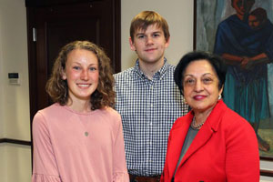 Barnard Scholars pose for the camera with President Núñez