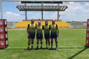 Rugby players pose for the camera