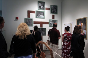 Parents gather around art to admire it.