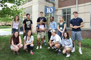 Student Orientaion Counselor poses with group of incoming students.