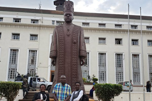 Professor Muchiri in front of the Statue of King Mutebi the second.