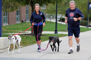 Cross country coach Kathy Manizza and Professor Charlie Chatterton finish an early-morning lap.