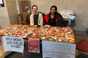 Students from the "Global and French Perspective on Women's Issues" class table the sticker fundraiser.