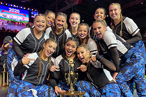 Picture of the dance team with their trophy. 
