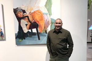 Multidisciplinary artist David Antonio Cruz poses in front og his art piece titled, "ITSNOTHATSERIOUSITSJUSTONEOFYOURLITTLEPRINCESSES"