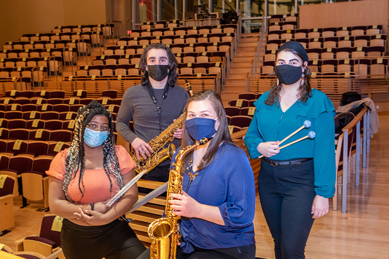 Erica Christofferson ’22 who plays the saxophone, Aaliyah Jones ’24 who plays percussion, Lucas Mariotti ’22 who plays the saxophone and Christiana Montalbano ’22 who plays percussion. 
