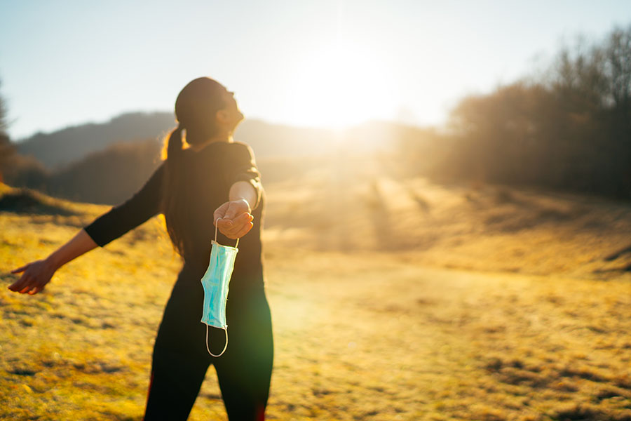 woman smiling at sun.