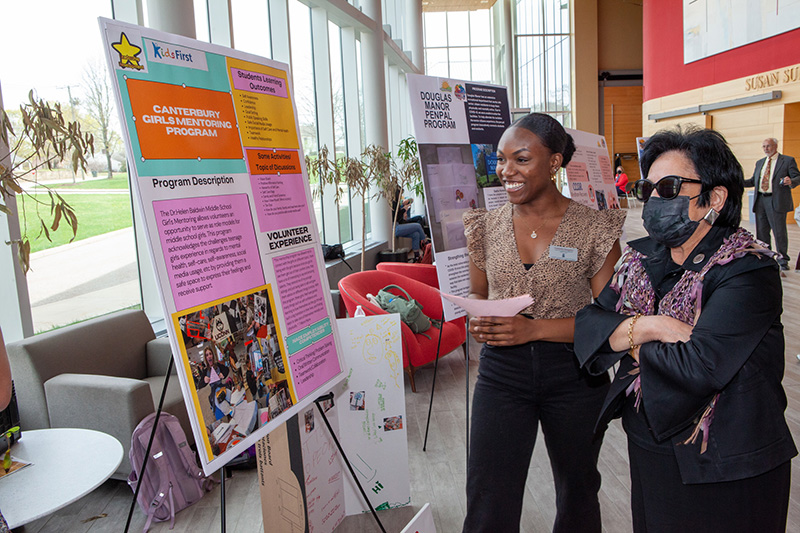 Student Tashieka Sangster shows President Nunez her work.