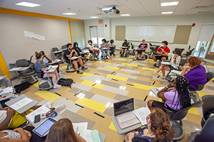 Students sit in a circle at STEP/CAP