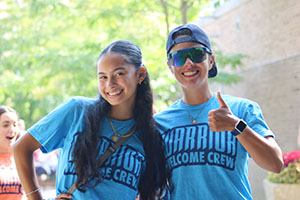 Two move-in team members smile for a photo 