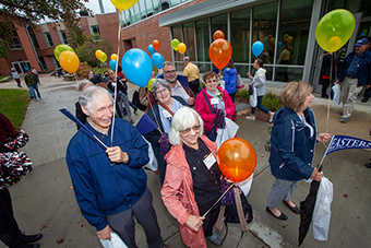 Eastern alumni march around campus.