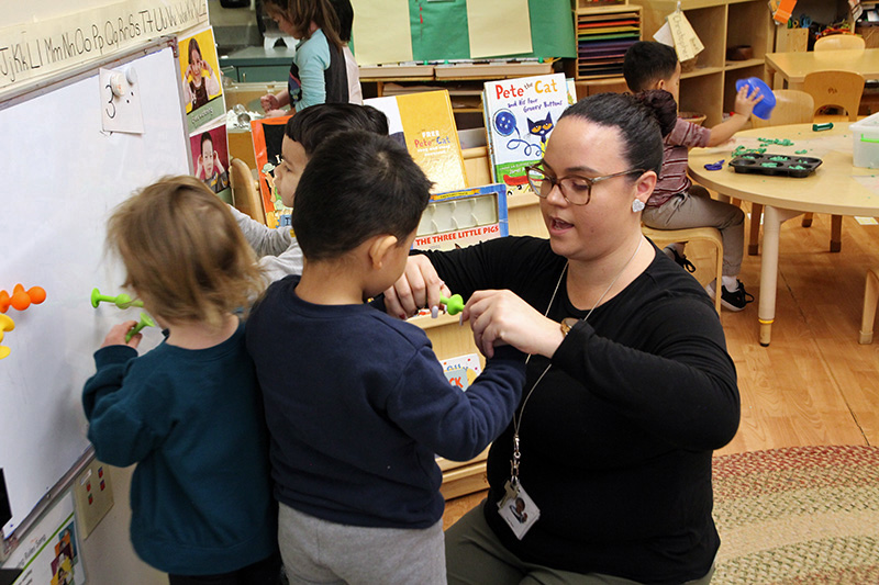 Preschool teacher Karla Alamo interacts with preschool students